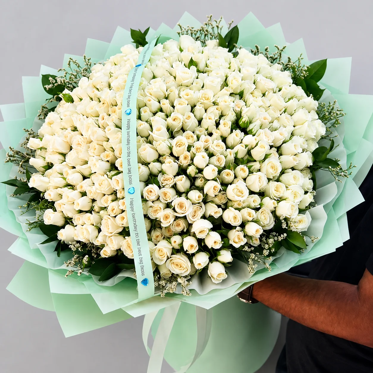 Large white rose bouquet wrapped in elegant mint green paper