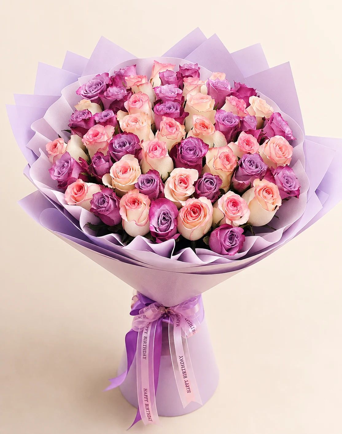 Rich purple and pink roses creating a unique and luxurious bouquet for someone special.