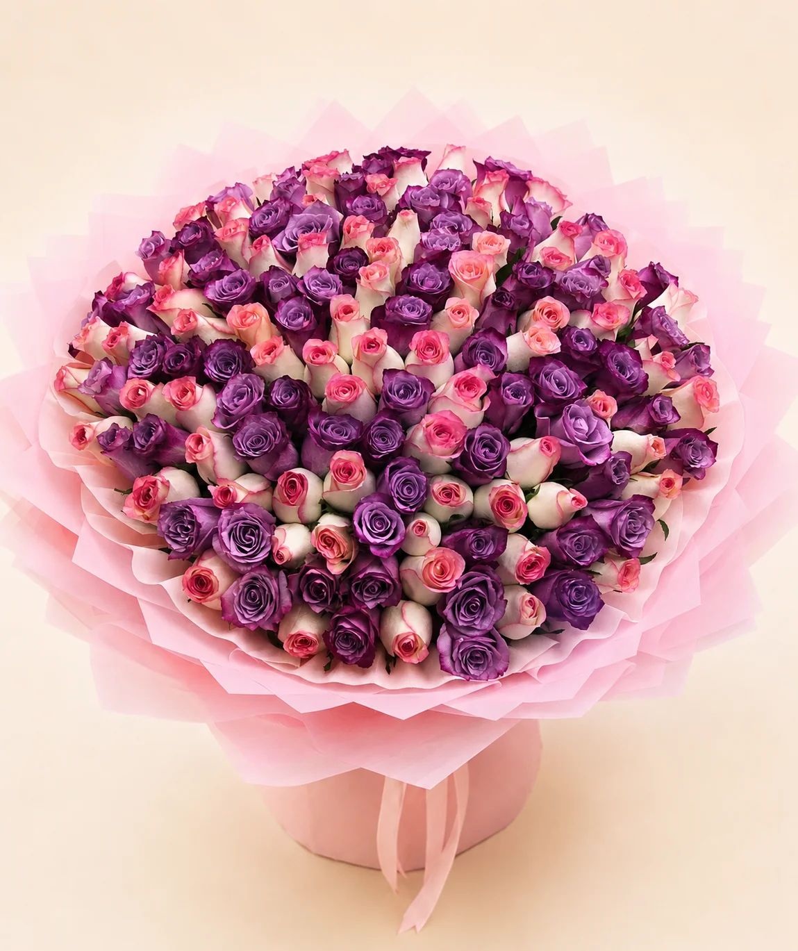 Rich purple and pink roses combined into a vibrant bouquet full of romance and character.