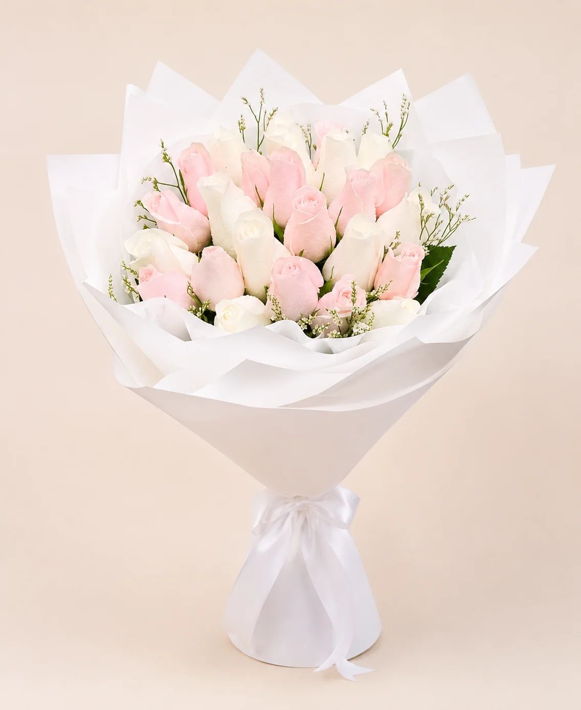 Soft pink and white roses combined into a graceful arrangement with a fresh and luxurious appearance.