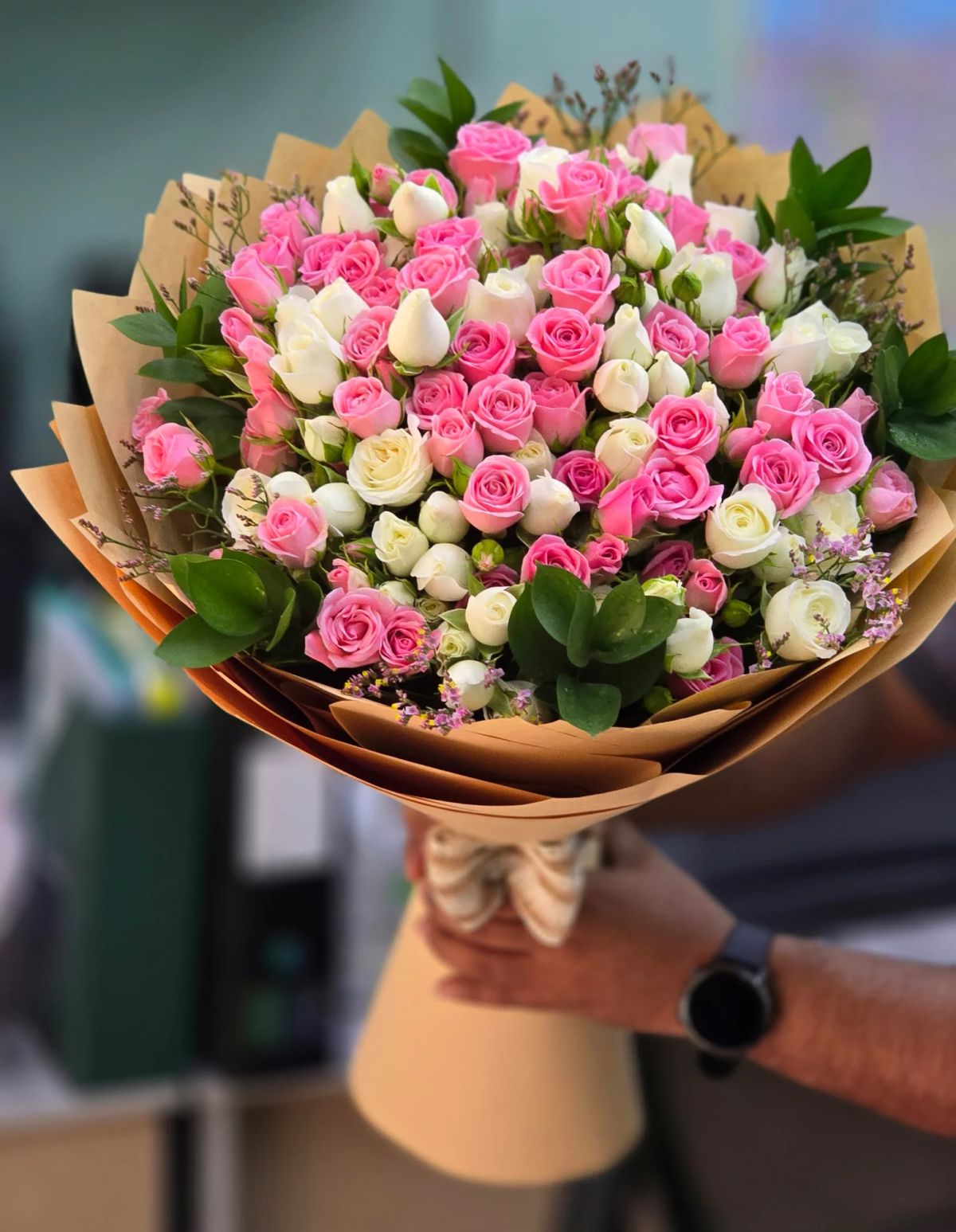 A generous arrangement of fresh pink roses presented in a stylish basket, creating a charming and luxurious floral gift for celebrations and special occasions.