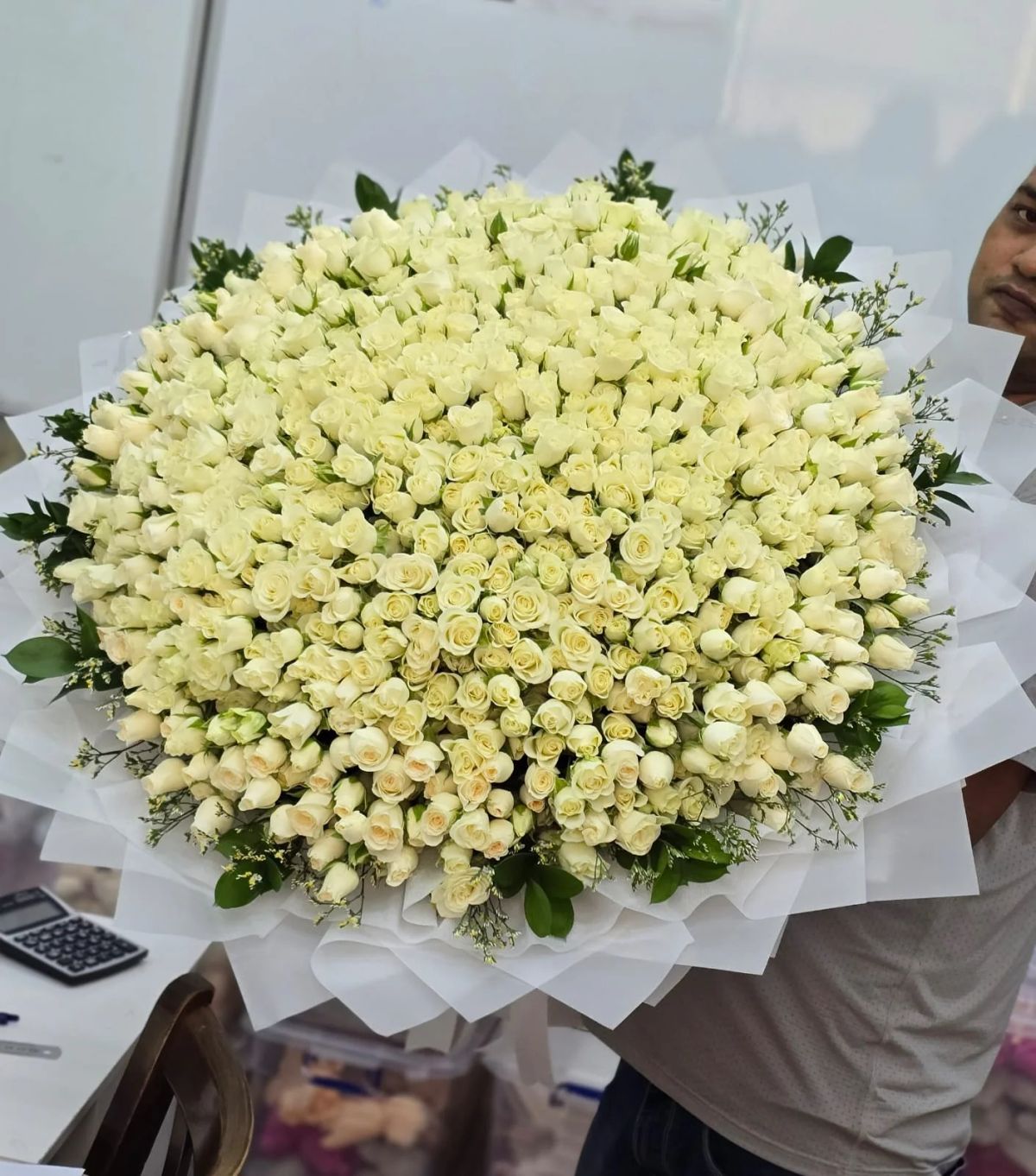 Elegant white roses arranged in a generous premium basket.