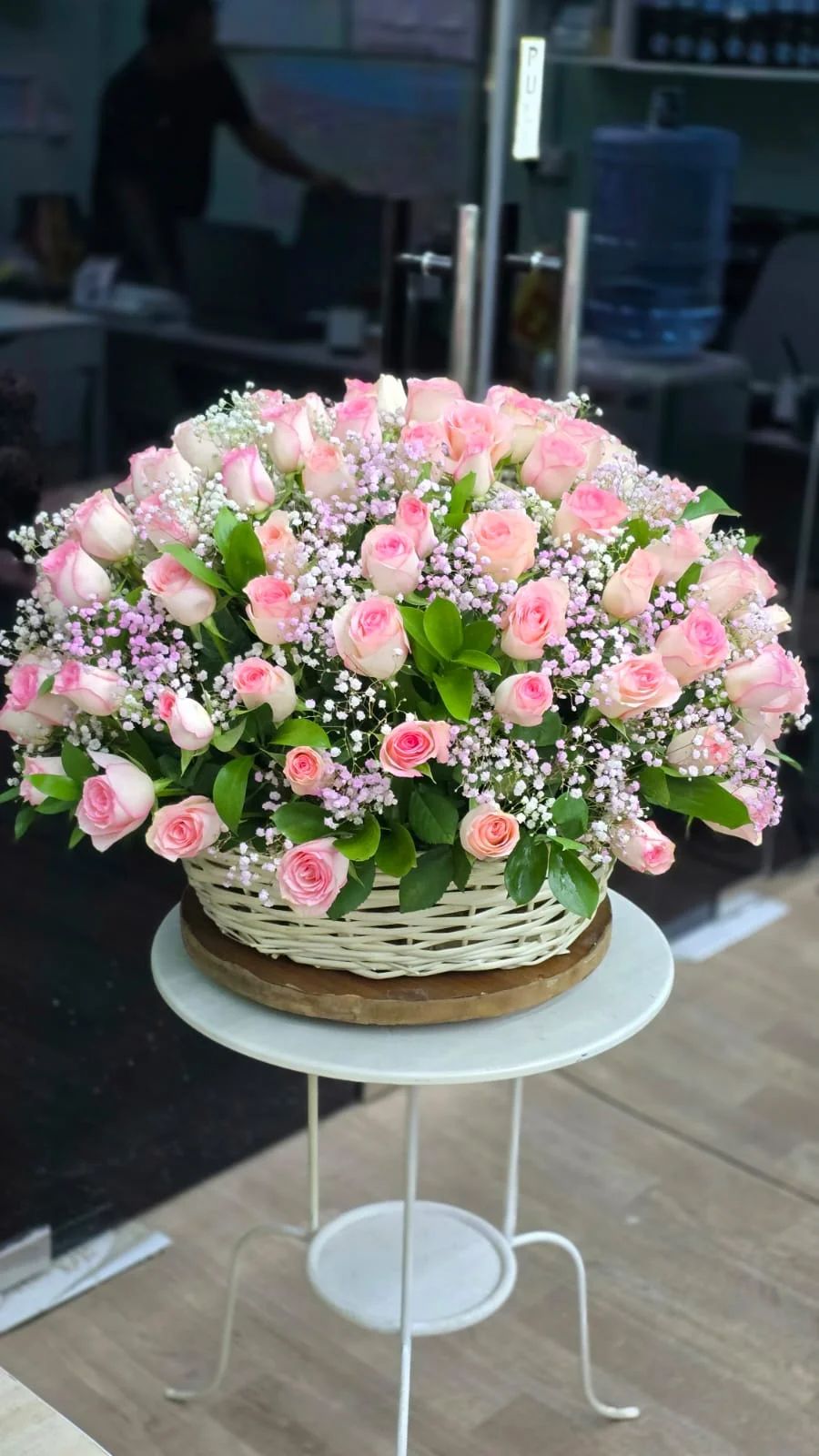 Soft blush and pink roses arranged in an elegant luxury basket.
