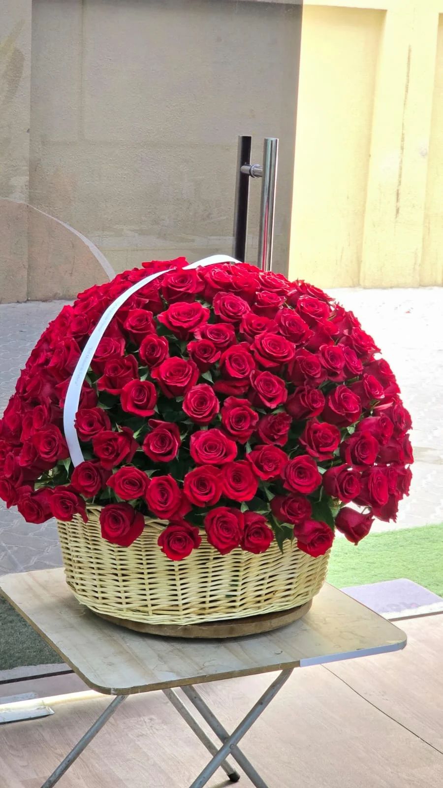 A luxurious basket filled with beautiful fresh red roses.
