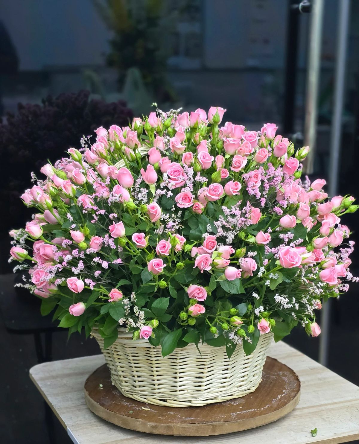 A charming dome-shaped basket filled with delicate soft pink spray roses.
