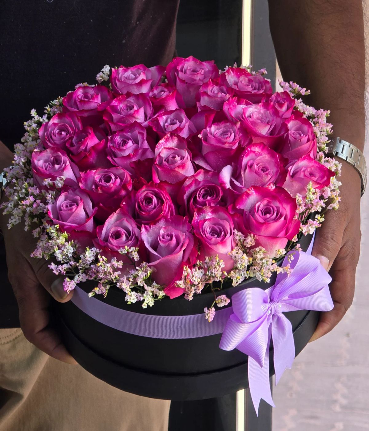 A vibrant basket filled with beautiful pink spray roses, perfect for romantic and joyful occasions.