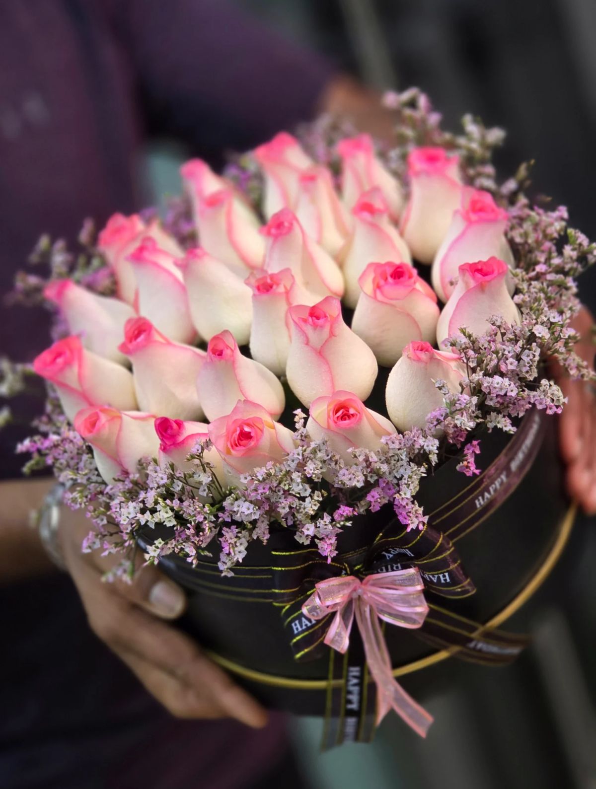 A delicate mix of pink and white roses arranged beautifully in a premium basket.